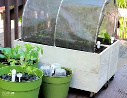 Open the door at the side and you will find a hose holder, complete with a hole at the back for it to come out of. 10 Free Raised Planter Box Plans For Your Yard Or Porch
