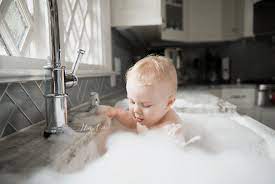 / baby taking bath in kitchen sink. Top 10 Baby Bathing Tips Kitchen Sink Baby Bath
