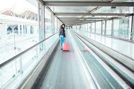 Chicago's o'hare terminal c featured multiple walkways, but because they were over twenty years old, o'hare has started taking the walkways out. Black Woman In The Moving Walkway At The Airport With A Pink Stock Photo Picture And Royalty Free Image Image 87728081