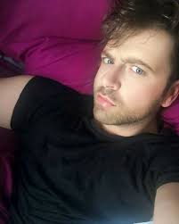 Mark Feehily looks effortlessly striking here — his piercing blue eyes and  slightly furrowed brows give off a mix of curiosity and intensity, while  the soft lighting highlights his smooth complexion. The