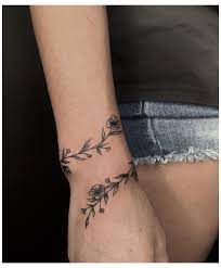 Has a tribal armband around his left wrist. Wrap Around Wrist Tattoo Flowers Vines Wraparoundwristtattooflowersvines Wrap Around Wrist Tattoos Wrap Around Tattoo Around Arm Tattoo