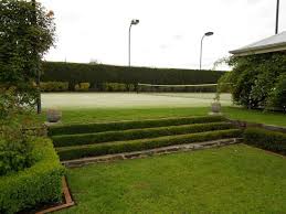 The actual tennis court is situated in a wooden hall with a honeycomb style arch roof. Grass Covered Steps Leading To Private Tennis Court Http Www Centroreservas Com Tennis Court Backyard Private Tennis Court Dream Backyard