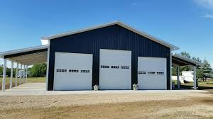 With the flexibility of post frame, you have greater flexibility over floor plan design and access, due to wood framing and widely spaced columns. Pole Barn Style Shop With Overhang Black White Metal Roofing Siding Metal Shop Building Building A Pole Barn Pole Barn Homes