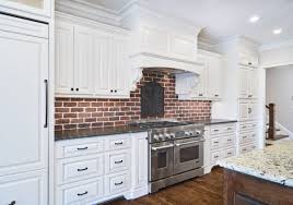 A Pretty White Kitchen With A Red Brick Backsplash Love That Stainless Steel Stove Kitchencabin Brick Backsplash Brick Wall Kitchen Brick Backsplash Kitchen