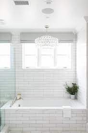 Overstock.com has been visited by 1m+ users in the past month An Oval Crystal Chandelier Hangs In Front Of A Window Dressed In A Platinum Gray Roman Shade And Framed By Li Bathtub Tile Bathroom Chandelier Cottage Bathroom