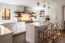 Either hidden or strategically placed brackets. White Kitchen With Dark Wood Floating Shelves Transitional Kitchen