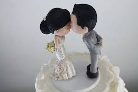 A simple wedding cake topper that makes a statement, the single letter (usually the couple's new shared last initial). Cute Couple Kiss Wedding Cake Topper Wedding Figurine Bride And Groom Handmade Fully Customizable Uniqu Wedding Cake Toppers Cute Couples Kissing Wedding