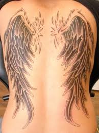 Grey ink angel wings and lettering chest tattoo. 55 Ingenious Angel Wings Tattoo Designs For Men Women