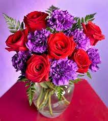 Why are the little purple flowers growing in my yard? Centerpiece Idea White Roses And Turquoise Carnations Red Flower Arrangements Purple Flower Arrangements Purple Centerpieces