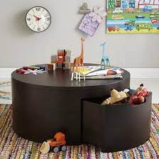 Wait, no, it's a play table that doubles as a coffee table. The Land Of Nod Kids Storage Table Round Coffee Storage Play Table In Play Tables Chairs Play Table Kids Play Table Coffee Table With Storage
