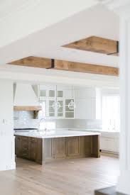 Kitchen With White Perimeter Cabinets And Large Square Wood Island White Ceiling Modern Farmhouse Kitchens Farmhouse Style Kitchen Farmhouse Kitchen Cabinets