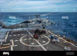 200218-N-HS716-1945 ATLANTIC OCEAN (Feb. 18, 2020) Boatswain's Mate 3rd  Class Lucas Shanksfoy, from Huntsville, Alabama, left, and Yeoman Seaman Thomas  Bey, from Atlanta, connect off-going supplies to an MH-60S Sea Hawk,  attached