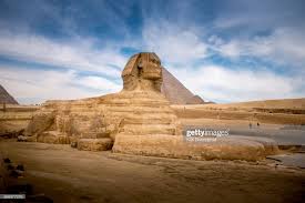 The Spinx Laying Down In Front Of The Great Pyramid Of Giza In Egypt Great Pyramid Of Giza Pyramids Of Giza Pyramids