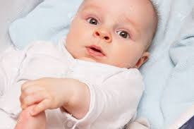 Surprised Tiny Newborn Baby Boy Holding His Feet Babies Care Concept Stock Photo Picture And Royalty Free Image Image 93715118