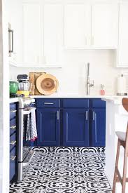 From cool azure to rich midnight, a blue kitchen will really make a statement in your home. Modern Budget Kitchen Remodel With Navy Blue And White Kitchen Cabinets Black And Wh White Kitchen Floor Kitchen Cabinets Black And White White Modern Kitchen
