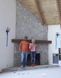 The completed fireplace is part of a stone fireplace wall. Makeover How We Replastered Our Mountain House Stone Fireplace