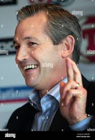 Scotland's National Coach George Burley crosses his fingers at a press  conference after naming his squad to face Norway at Hampden Park, Glasgow  Stock Photo