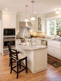 Kitchen designs with islands and oven. A Small L Shaped Kitchen With Double Eye Level Oven Square Kitchen Layout White Kitchen Traditional Kitchen Layout