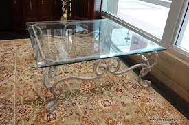 The design is contemporary, and the translucent top shows a breathtaking antique style coffee table with a gilded frame of wrought iron. Win Square Glass Top Coffee Table Scrolling Wrought Iron Legs With A White Finish Beveled Edges Est Glass Top Coffee Table Coffee Table Iron Coffee Table