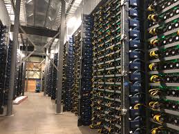 Row of bitcoin miners set up on the wired shelfs computer for stock. We Setup And Ran One Of The Largest Crypto Mining Facilities Bitcoinmining