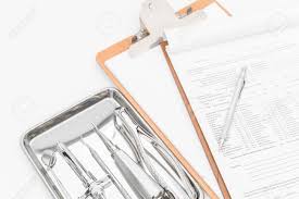 dental tools equipment and dental chart on white background