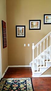 Benjamin Moore Spice Gold Walls Cherry Floors White Trim And Black Accents Gold Paint Colors Paint Colors For Living Room Gold Living Room Walls