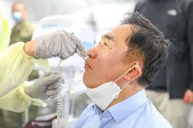 Spc. Kim Sungji, 65th Medical Brigade, takes Mr. Jung,