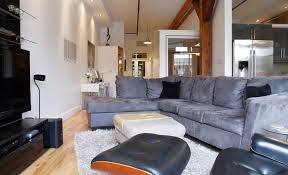 Larger spaces can accommodate a sofa table, or console table, as in this living room. How To Decorate With Oversized Sofas