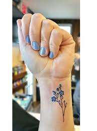 Wildflower Tattoo On Wrist Small Dainty Tattoo With Clean Lines Feminine Tattoo Dainty Tattoos Wildflower Tattoo Tattoo On Wrist