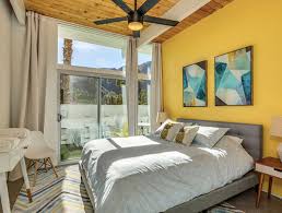 Photo about wooden table between grey and yellow armchair against white wall with poster in living room interior. 29 Yellow Bedroom Decor Ideas Sebring Design Build