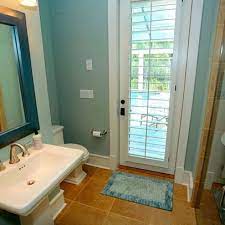A contemporary outdoor bathroom with an oval tub, tiles and a stone wall. 12 Pool Bathroom Ideas Pool Bathroom Home Small Bathroom