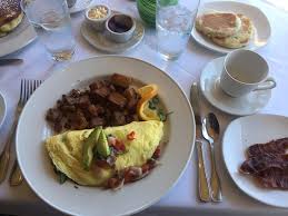 wonderful coffee omelette with potatoes bacon and muffin