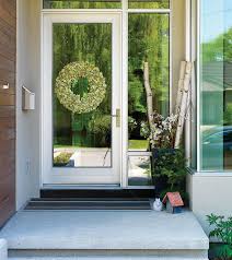 Design ideas for a large modern front door in austin with white walls, concrete floors, a sliding front door, a light wood front door and grey floor. Stylish Doors In Calgary Edmonton Lux Windows Doors