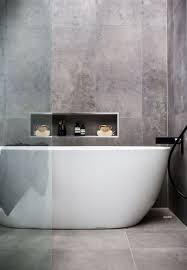 Simple Raw Concrete Look Walls And Floor With White Free Standing Bath Niche At Bath Contemporary Bathroom Tiles Grey Bathroom Tiles Bathroom Inspiration