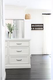 Dark kitchen cabinets and countertops with white backsplash. White Kitchen With Dark Wood Floors Would We Do It Again