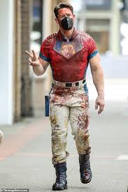 The actor and pro wrestler, 43. John Cena Flashes A Peace Sign While Strolling Around The Vancouver Set Of Peacemaker Geeky Craze