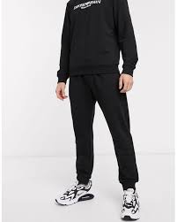 Pants having a drawstring or elastic waist and usually elastic cuffs at the ankle that are worn especially for exercise. Emporio Armani Cotton Logo Draw Cord Joggers In Black For Men Lyst