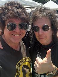 I'm at the flea market and notice this Rock 'N' Roll looking guy who I  never see there from the distance at a vinyl dealer's table. As I walk  over, I hear