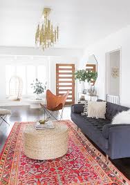 Outfit dark wood floors with natural woven area rugs, and hang a shimmering chandelier above a weathered wood coffee table. Red And Gold Rug Living Room Novocom Top