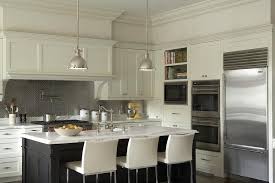 It is also heat resistant, making it an ideal choice for food preparation. Ivory And Black Kitchen Cabinets With Stainless Steel Hex Tile Backsplash Transitional Kitchen