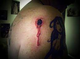 Colorful bullet with banner tattoo design. Amazing Bullet Hole Tattoo On Right Shoulder By Emily