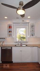 The White Koch Kitchen Cabinets Accented By A Dark Wood Finish Island And Richelieu Hardware Transitional Kitchen Design Kitchen Design Kitchen And Bath Design