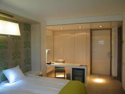 Throw in some custom wood work and wall paneling, a fireplace with wood and stone mantle, and a beautiful stained wood king size bed with cream bedding and you end. Cozy Master Bedroom With Solid Finish Study Table By The Work Worm Architects