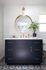 They bring task lighting to the area over your vanity and should easily light your face when you use your bathroom vanity mirror.since these lights work in tandem with your bathroom mirror, it's important to consider the shape, size, and style of your mirror when selecting your vanity fixtures. The Gameplan Round Mirror In The Bathroom Diy Playbook Modern Bathroom Tile House Bathroom Bathroom Floor Tiles