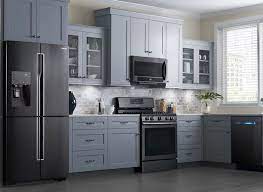 Stainless steel appliances add a flash of sleek modernism but the whole room is anchored by the dark wood island with marble countertop. 20 Home Decor Trends That Made A Statement In 2016 Kitchen Design Kitchen Remodel Black Stainless Steel Appliances