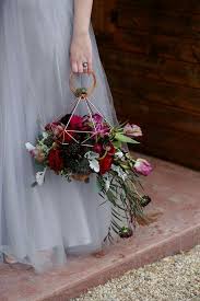 If you really want to spice things up and not go too crazy, try this statement wedding bouquet with different variations of burgundy and red flowers sat in dull green succulent leaves. 7 Ideas For A Unique Floral Bouquet Wedded Wonderland