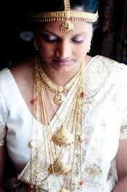 Traditional Sri Lankan bride. The wedding jewellery comprises of Nalalpata, which is a gem studded hair accessory. The piece is crafted is gold and is ... - Traditional-Sri-Lankan-bride
