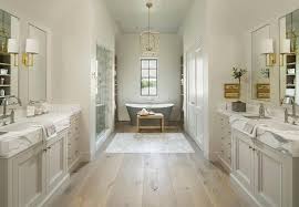 Pale Gray Washstands Facing Each Other Across From Pine Wood Floors Transitional Bathroom