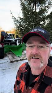 Kubota Tractor with Bucket Taking Up Stumps