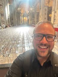 A personal reflection from our Director, Kyle Cook: “I just conducted The  Outer Banks Chorus at St. Peter's Basilica at the Vatican. During our  communion song, “Room at the Table,” the text
